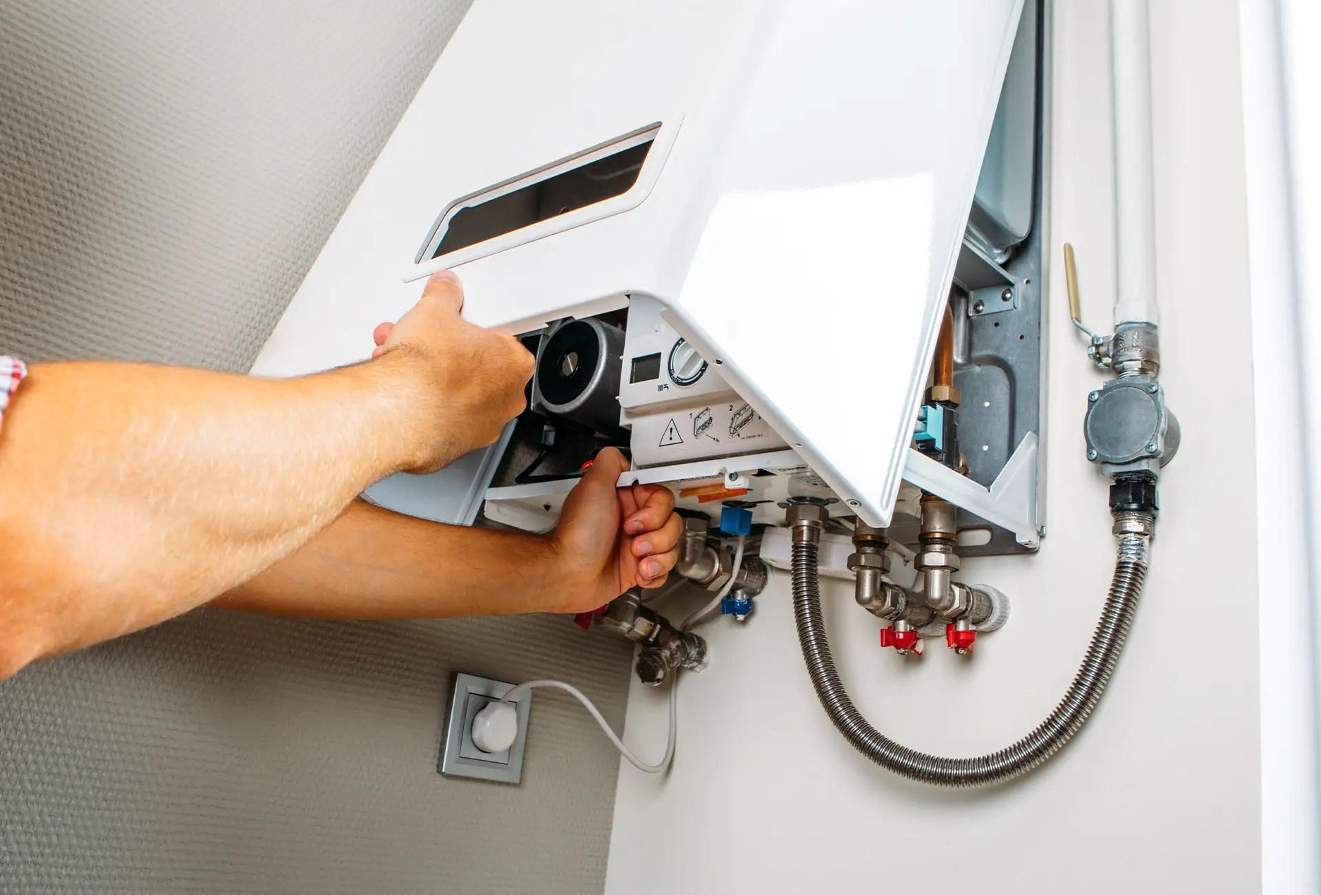 GU Services engineer servicing a wall-mounted gas boiler